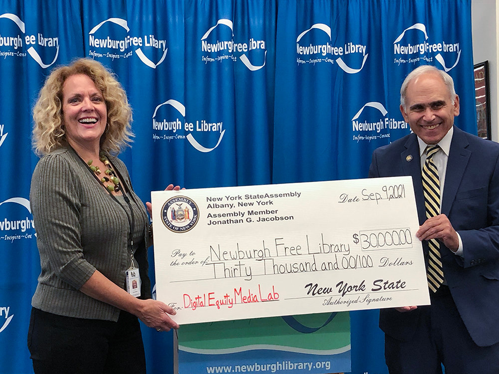 Newburgh Free Library Executive Director Mary Lou Carolan accepts a $30,000 check from Assemblyman Jonathan Jacobson.